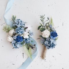 two blue and white flowers are tied together