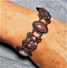 "REDUCED FROM $89.90.  Victorian Style Lavender Bracelet  Beveled Diamond Shaped Givre Lavender Alternating Navette Glass Fire Opals Colorful  Bronze Bracelet    This beautiful large adjustable 7 1/2\" to 9\" x 7/8\" Bright pink rhinestones glass givre (looks like stained glass), pointed star stone, with large glass fire opas; very nice and subtle touches.  A Joy to behold! Other items in final 4 pictures, I also listed today!" Lavender Bracelet, Bronze Bracelet, Fire Opals, Bronze Bracelets, Funky Jewelry, Jewelry Lookbook, Hippie Jewelry, Diamond Shaped, Pink Rhinestones