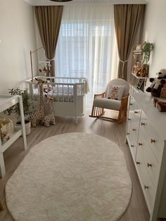 a baby's room is decorated in neutrals and whites, with teddy bears on the floor