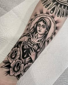 a black and white tattoo on the arm of a woman