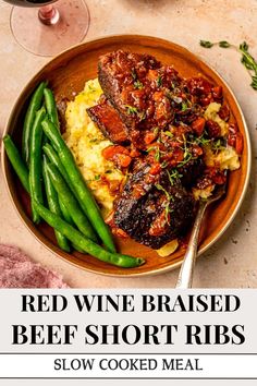 red wine braised beef short ribs with mashed potatoes and green beans in a bowl