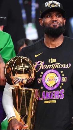 the lakers basketball player holding his trophy