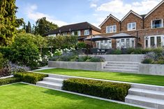 an outdoor garden with steps leading up to the house