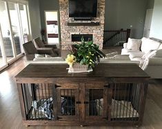 a living room filled with furniture and a flat screen tv mounted on top of a wooden table