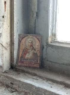 an image of jesus on the side of a window sill next to a sign