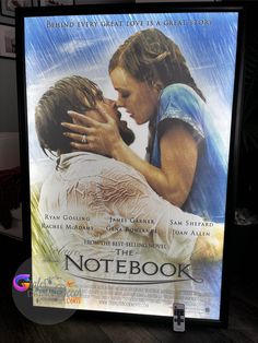 a movie poster for the notebook with two people kissing each other and rain falling down on them