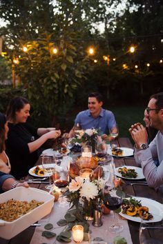 a group of people sitting around a dinner table