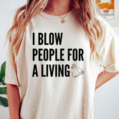 a woman wearing a t - shirt that says, i blow people for a living