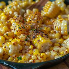 a bowl filled with corn on the cob and garnished with seasoning