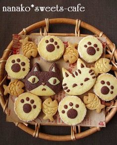 a basket filled with cookies decorated like cats and dogs