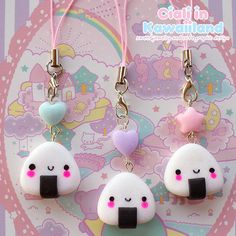 three cute little kawai land charms hanging from pink cord with heart on it's ear