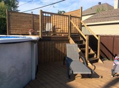 a backyard with a hot tub and wooden decking