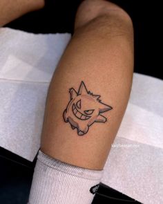 a person with a tattoo on their leg that has a cartoon character drawn on it