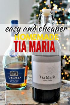 a bottle of wine sitting on top of a counter next to a christmas tree with the words easy and cheap homemade tamari