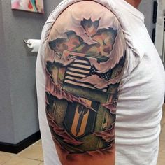 a man with a tattoo on his arm that has an american flag in the background