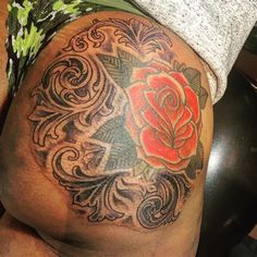 a man with a rose tattoo on his thigh