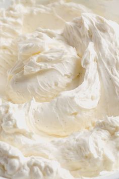 a white bowl filled with whipped cream on top of a table