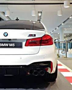 the back end of a white bmw m5