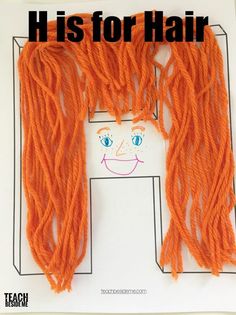 an orange hair cut out on top of a piece of paper with the words h is for hair