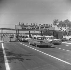 an old black and white photo of cars at six flags parking