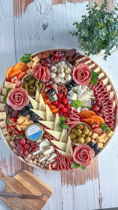 a platter filled with different types of cheese and meats