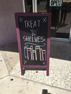 a sign on the sidewalk that says treat to shelves