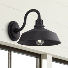 an outdoor light mounted on the side of a house