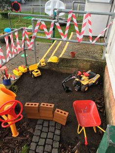 a yard filled with toys and construction equipment