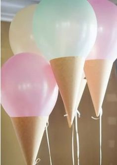 three ice cream cones with balloons attached to them