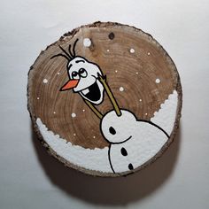 a piece of wood with an image of a cartoon character on it and snow flakes