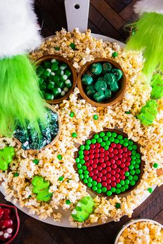 an overhead view of some food on a plate with green and red candies in it