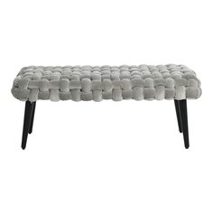 an upholstered bench with black legs and grey fabric on the top, against a white background