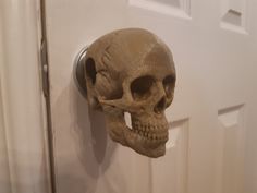 a fake human skull mounted to the side of a door