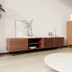 a living room with white walls and wooden furniture