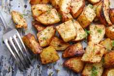 a plate full of potatoes with a fork