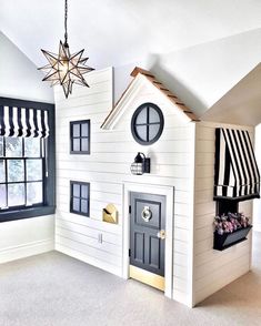 a doll house with black and white striped curtains