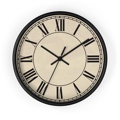 a black and white clock with roman numerals on it's face is shown