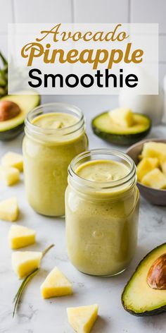 avocado pineapple smoothie in mason jars with fresh fruit around the jar