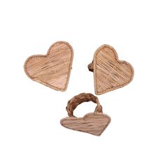 two heart shaped wooden magnets sitting next to each other