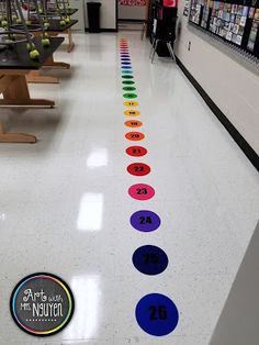 a long line of colorful circles on the floor in a store