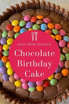 a chocolate birthday cake with colorful candies on top and the words, easy from scratch chocolate birthday cake