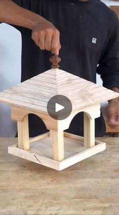 a man is making a small wooden table