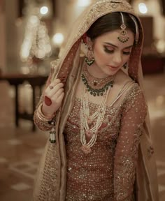 a woman in a bridal gown and jewelry