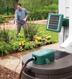 a man standing next to a green and white air conditioner in front of a house