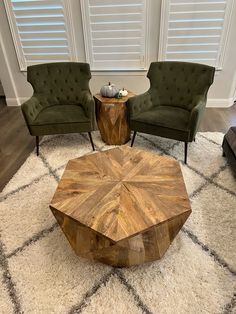 a living room with two chairs and a coffee table on top of a shaggy rug