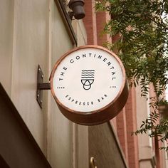 a sign hanging from the side of a building that says continental espresso bar