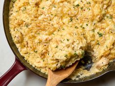 a skillet with some food in it and a wooden spoon