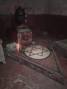 a candle is lit in the middle of a room with an altar and other items