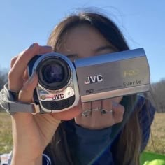 a woman holding up a camera in front of her face