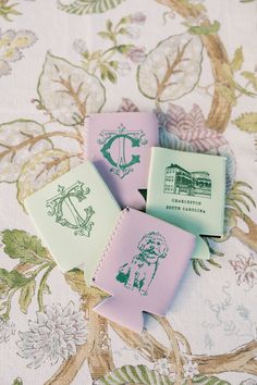 three small erasers sitting on top of a floral table cloth covered in green and pink